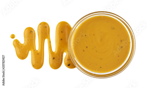 Mustard sauce in bowl isolated on white background. Top view