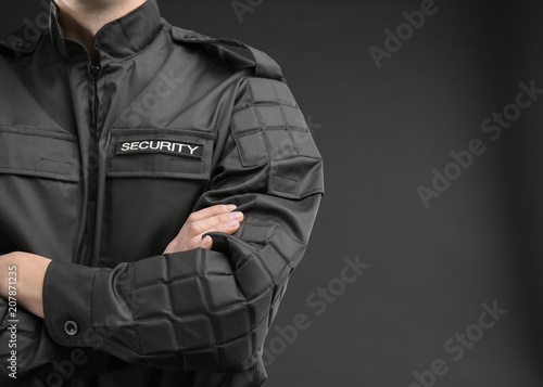 Male security guard in uniform on dark background, closeup