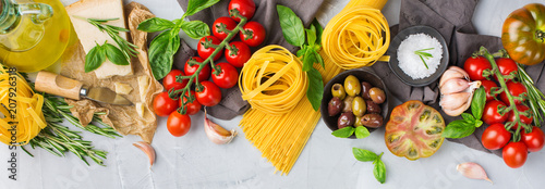 Italian food ingredients with pasta, tomatoes, cheese, olive oil, basil