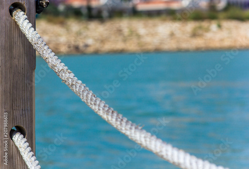 Rope handrails made of rope against the blue sea
