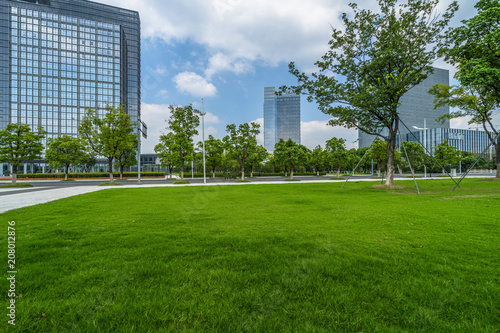 beautiful green field near modern office building.