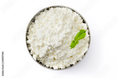 Fresh cottage cheese in a metal bowl isolated on white background. Top view