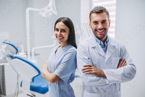 doctor and assistant with crossed hands