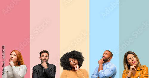 Cool group of people, woman and man thinking and looking up expressing doubt and wonder