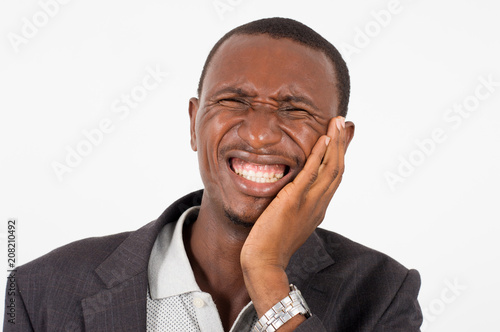 young man in suit standing on white background, suffering.