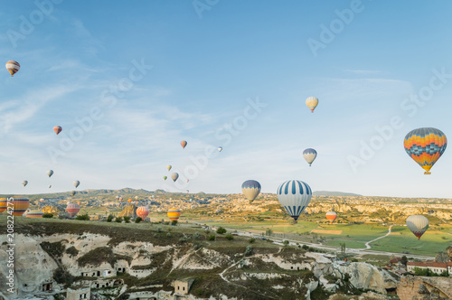 front view of colorful hot air balloons flying over city in Cappadocia, Turkey