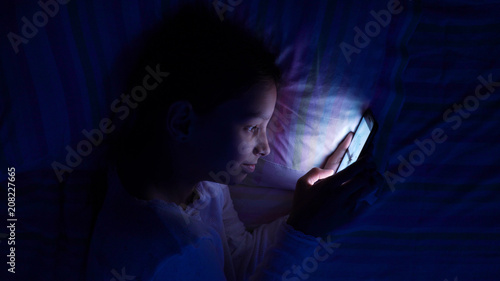 digital modern device addiction. gadget night sleeplessness. young caucasian girl browsing chatting playing serfing network with tablet bed. mobile phone apps.