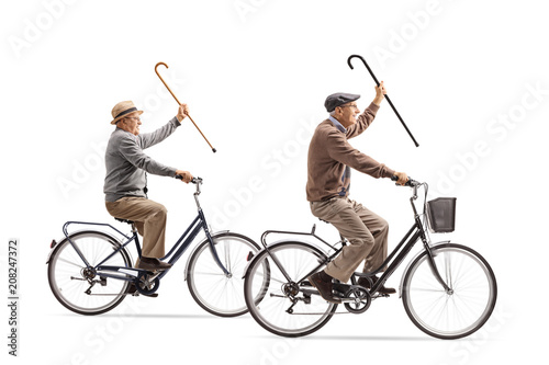 Two cheerful elderly men with canes riding bicycles