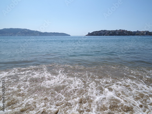 Mexican sandy beach at bay of ACAPULCO city in Mexico with luxury panoramic view and waves of Pacific Ocean