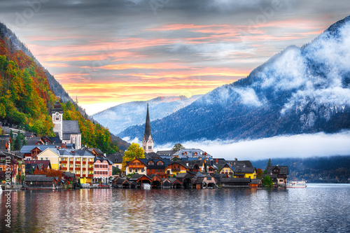 Scenic view of famous Hallstatt mountain village with Hallstatter lake. Foggy autumn sunrise on Hallstatt lake