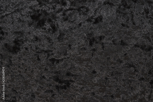 Luxurious feel of a black or dark gray velour cloth enhanced by its highly detailed texture background, featuring a lush and plush surface created from densely packed and closely woven fibers.