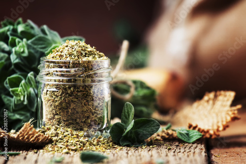 Dried and fresh oregano, vintage wood background, rustic style, selective focus