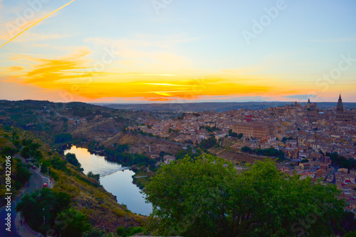 Sunset at lookout of Toledo, Spain. Tajo river around the city and Alcazar and Cathedral at background. 
