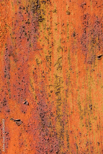 Texture of old orange wall with pealing paint