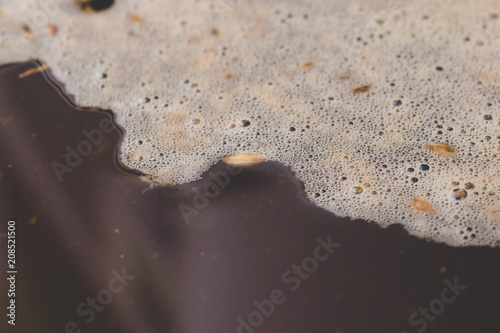 surface of craft beer during mashing process. Craft beer brewing from grain barley pale malt in process. Ale or lager from pilsner malt.