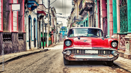 Old red Chevrolet car parked in a street of havana