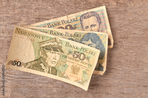 Old Polish banknotes. Brown wooden desk background.