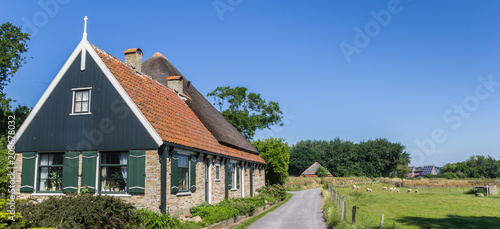 Panorama of a traditional dutch house in the landscape of Texel island, The Netherlands