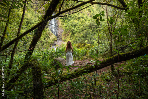 Girl watching the Cascade Blanche waterfall in Salazie, Reunion Island