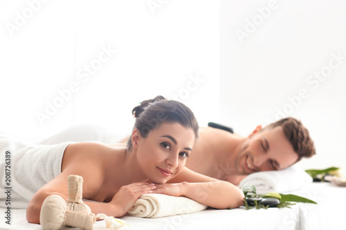 Happy young couple relaxing in spa salon