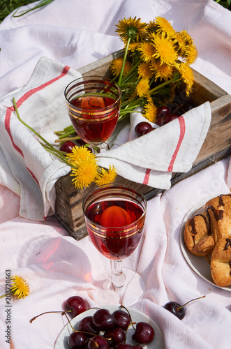 Picnic with red wine, croissants and cherries 