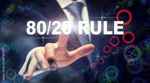 A businessman pressing a 80/20 Rule business concept on a graphical display of cogs