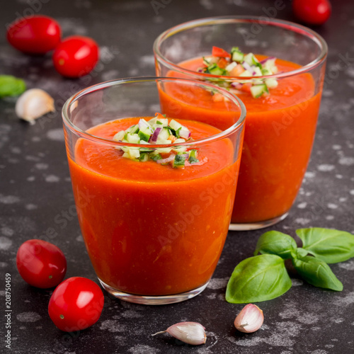 Italian red tomato cold gazpacho soup in glass, with cucumber, onion, Basil