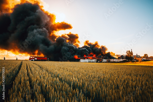 Firefighters battle with huge fire among fields
