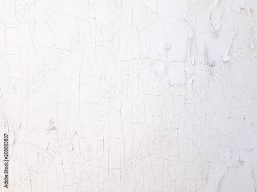 shabby old flaky plaster wall background. white damaged crackled paint. weathered worn out surface. copyspace concept