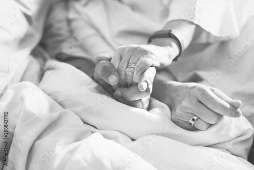 Closeup of couple holding hands together