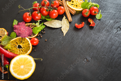 Different vegetables and spices on black background. Top view. Flatlay. Copy space
