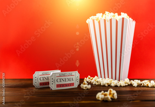 Red and White Bucket Of Popcorn With Two Red Movie Ticket