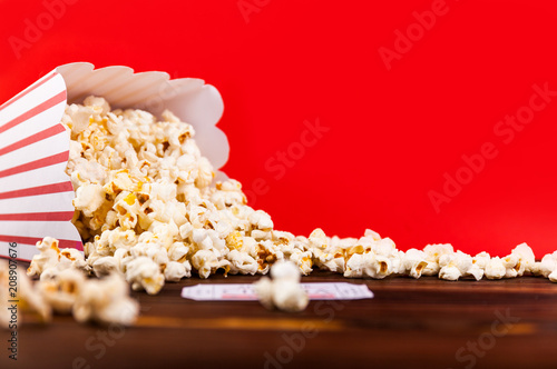 Red and White Bucket Of Popcorn With Two Red Movie Tickets