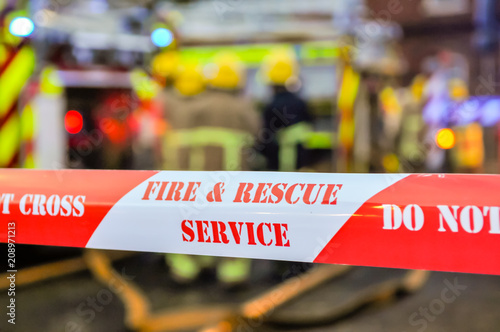 Fire brigade place cordon tape around a suspected arson scene to keep people safe and preserve evidence.