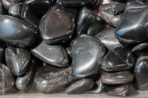 metallic gray tumbled hematite gemstone as mineral rock