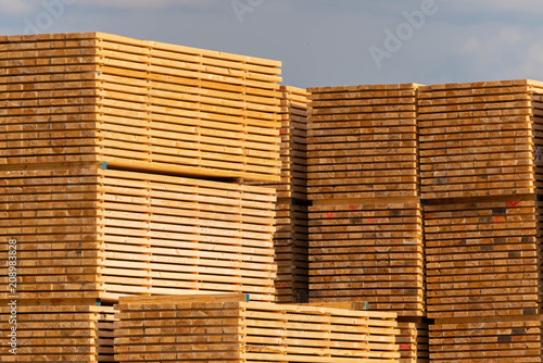 Stacks of wooden beams, storaged wood.