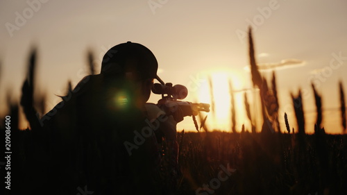 A sniper rifles from a rifle with an optical sight. On the Sunset. Sports shooting and hunting concept