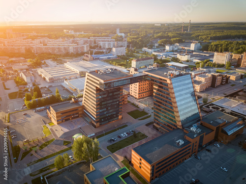 Aerial view of academpark technopark of the Novosibirsk Academic Township - a large building with laboratories and innovative projects, inventions of a technical charactere at sunset on a sunny day