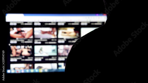 Man silhouette choosing adult videos in internet, parental control software