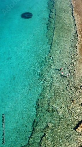 Aerial drone bird's eye view photo from turquoise clear water seascape in island of Shinousa or Schinoussa, Cyclades, Greece