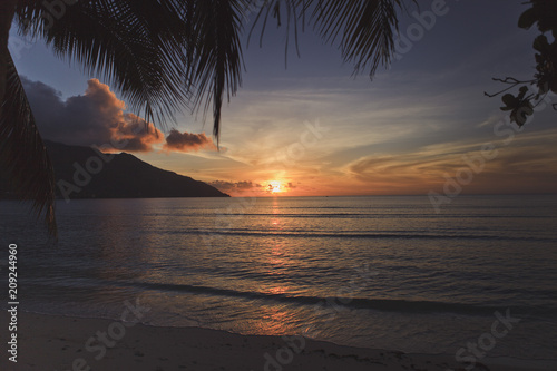 Stunning sunset on the beach of a tropical island.