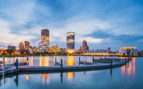 milwaukee skyline at night with reflection in lake michigan.