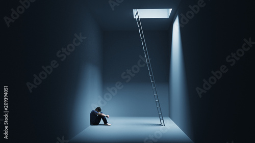 A man is sitting depressively in a room with a ladder