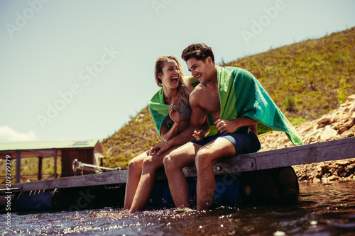 Couple enjoying on pier at the lake