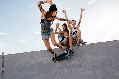 Skater girl rides on skateboard at skate park