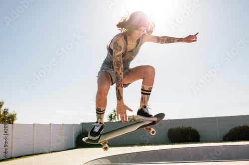Women skater doing ollie on skateboard