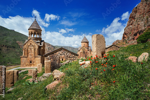 Noravank monastery complex built on ledge of narrow gorge. Sunny day in mountains. Tourist and historical place. Travelling to Armenia in summer.