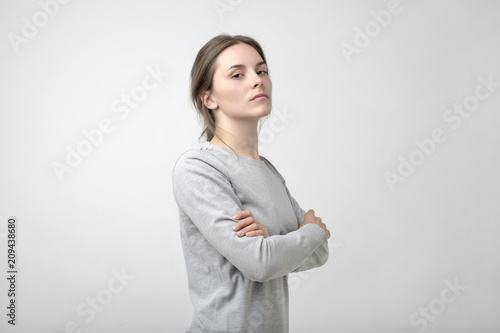 The young woman portrait with proud and arrogant emotions on face.