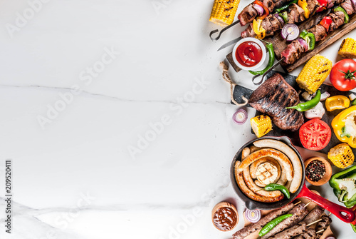 Assortment various barbecue food grill meat, bbq party fest - shish kebab, sausages, grilled meat fillet, fresh vegetables, sauces, spices, white marble background, above copy space
