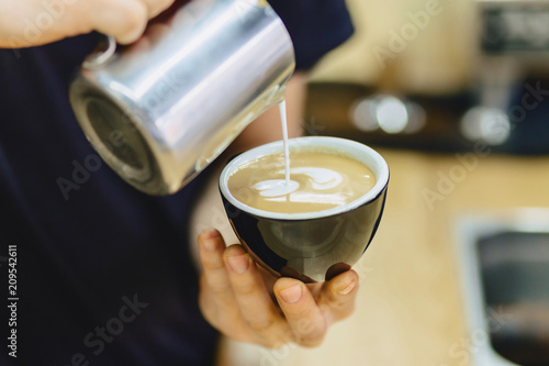 barista makes coffee closup